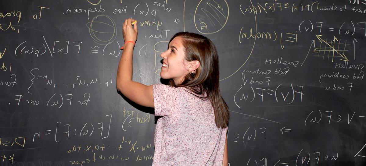 Student in front of chalkboard