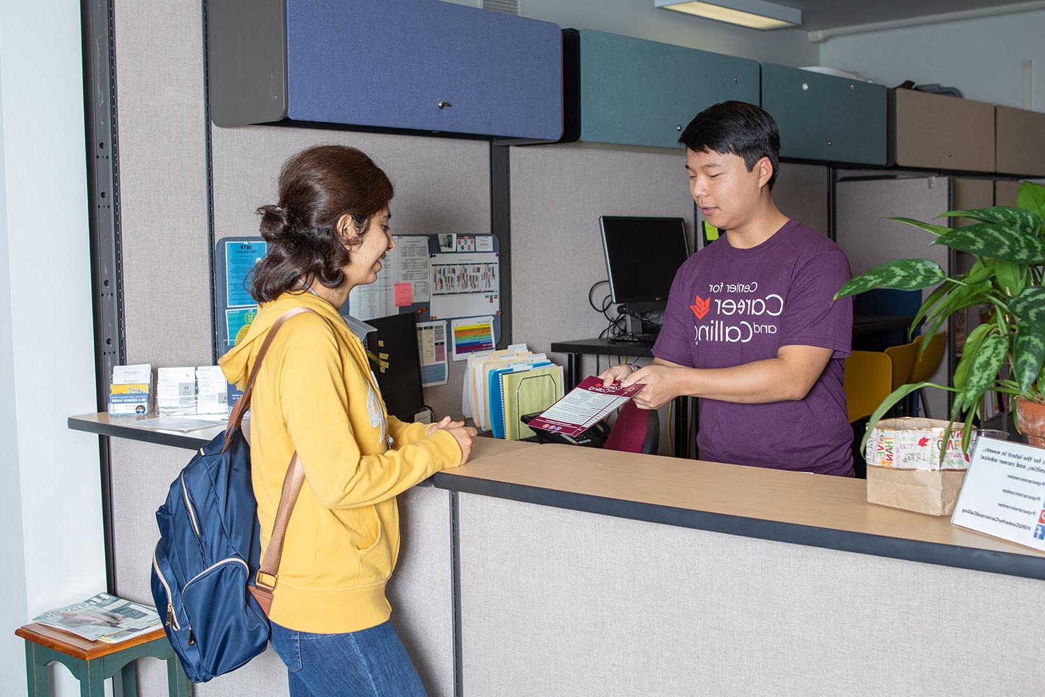 A peer career advisor helps a student in a walk-in session